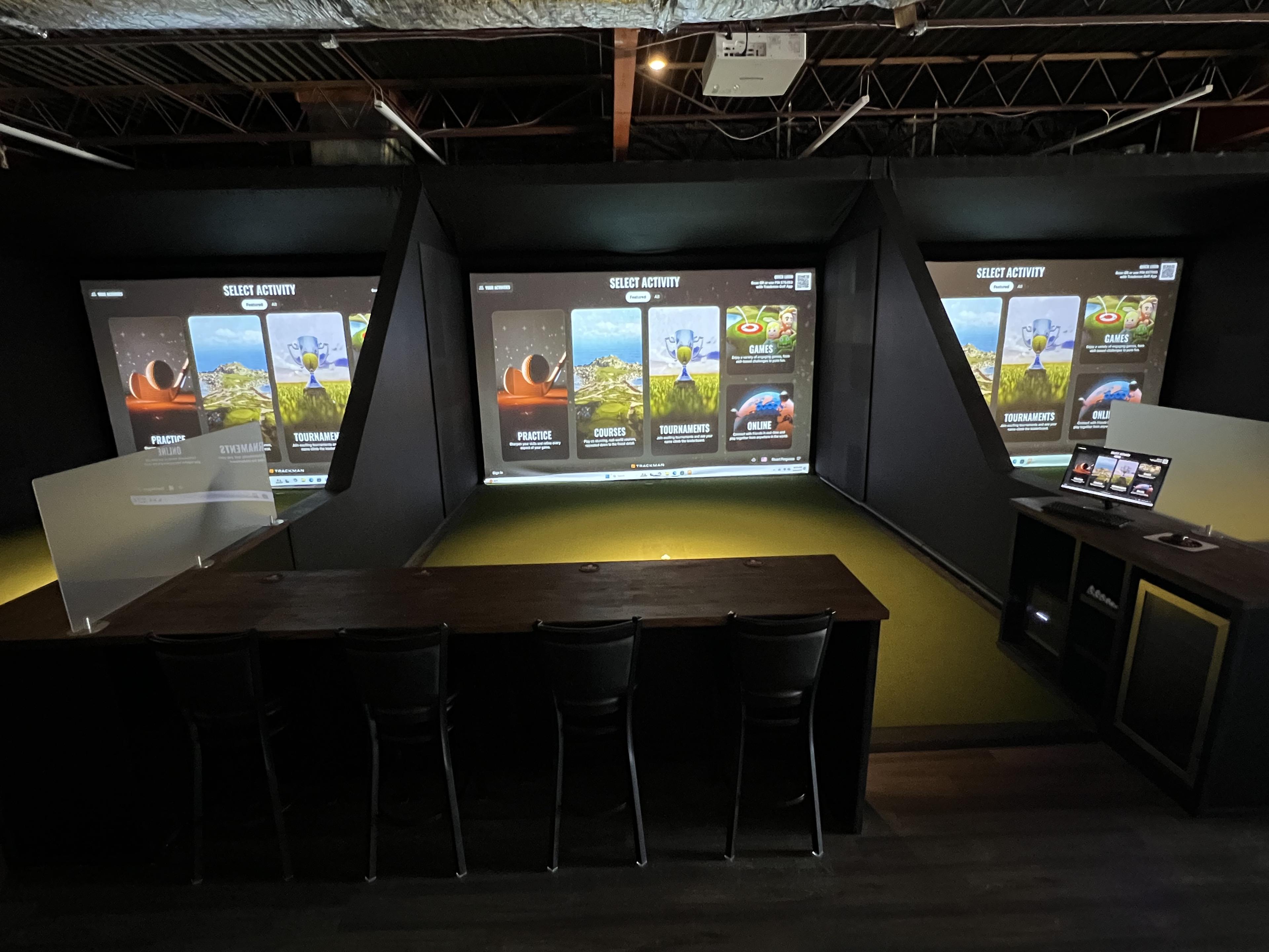 Golfers playing on Endless 18 indoor golf simulators